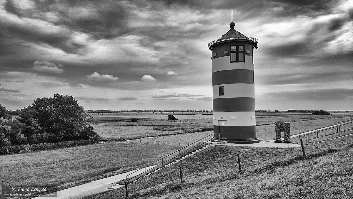 "Between Clouds and Endless Horizons – Pilsum Lighthouse near Greetsiel" "Between Clouds and Endless Horizons – Pilsum Lighthouse near Greetsiel"