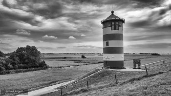 "Between Clouds and Endless Horizons – Pilsum Lighthouse near Greetsiel" "Between Clouds and Endless Horizons – Pilsum Lighthouse near Greetsiel"